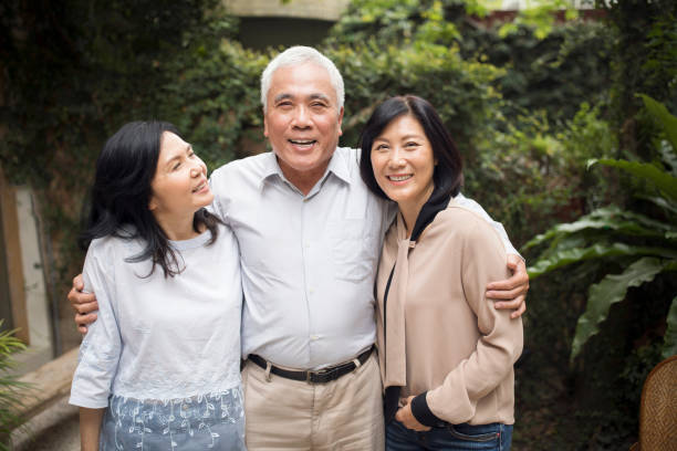 istock Happy man hugging two beautiful women 1202373876