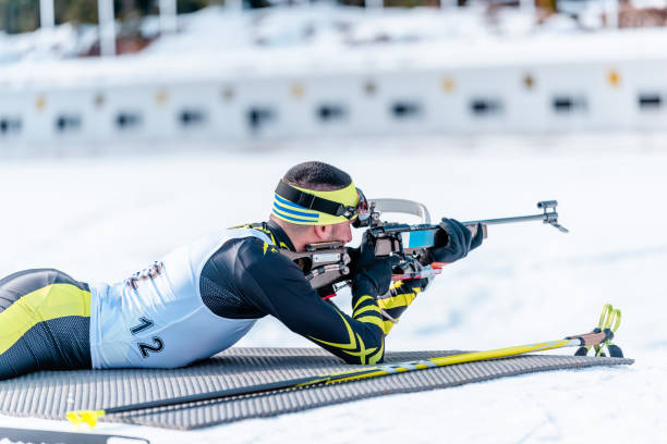 istock Biathlete rifle shooting lying position. Shooting range in the background. Race concept 1202373989