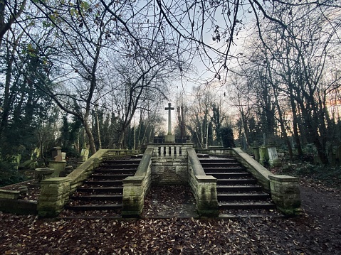 Old stone stairs to a big cross in Abney Park Cemetery, Stoke Newington, East London