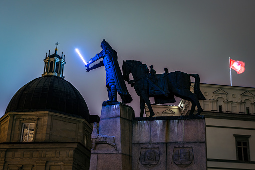 Vilnius, Lithuania - January 26, 2020: Gediminas statue with glowing sword in Cathedral square illuminated for 697  city birthday celebrations during Vilnius Festival of Light 2020.