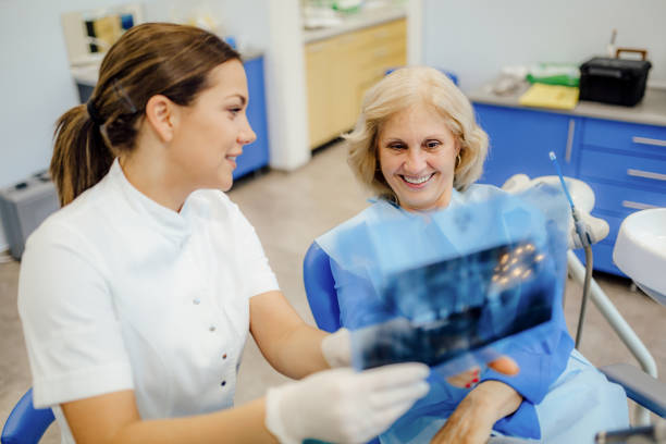 istock Young dentist explaining the x ray scan to her patient 1202377122