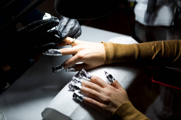 istock Removal of gel nail polish using a foil. Manicure. 1202380040