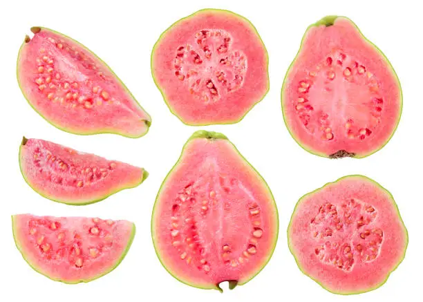 Isolated cut guava fruits. Pieces of green pink fleshed guavas isolated on white background with clipping path