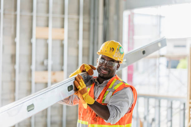 istock African-American construction worker carrying metal beam 1202382911