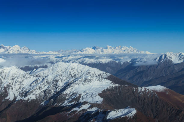 istock Snow capped mountains under a bright blue sky 1202383200