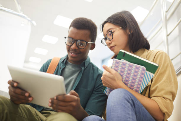 casal de estudantes na faculdade moderna - reading early teens teenager adolescence - fotografias e filmes do acervo