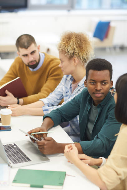istock Group of Young People Studying in Library 1202384481
