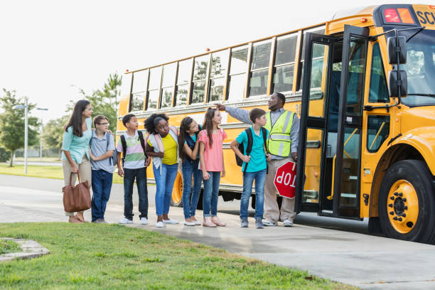 istock Middle school class boarding bus, boy with down syndrome 1202387725