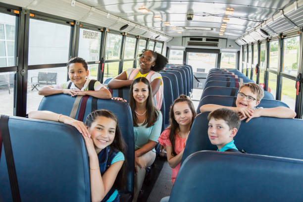 istock Teacher, students, boy with down syndrome on school bus 1202387750