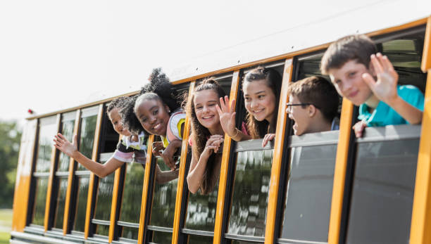 istock Students riding school bus, boy with down syndrome 1202387855