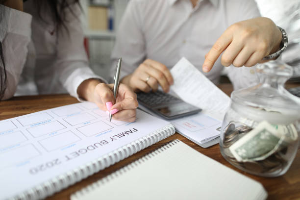 istock Man and woman summing-up revenue 1202391385