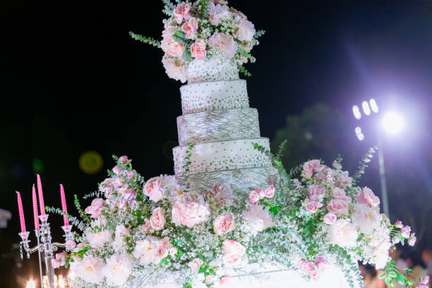 istock Decoration wedding with cake bubble and lighting in ceremony. Beautiful Wedding Cake. Abstract blurred soft of wedding cake and bubbles in the wedding banquet. 1202393914