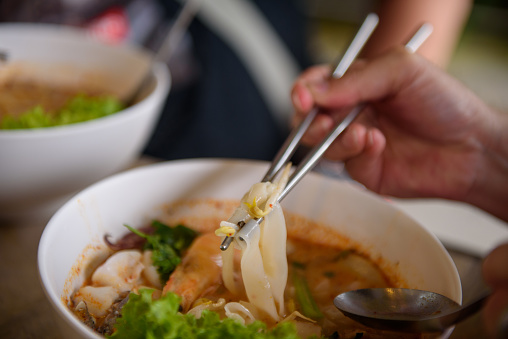 Use of chopstick for Tomyum noodle soup