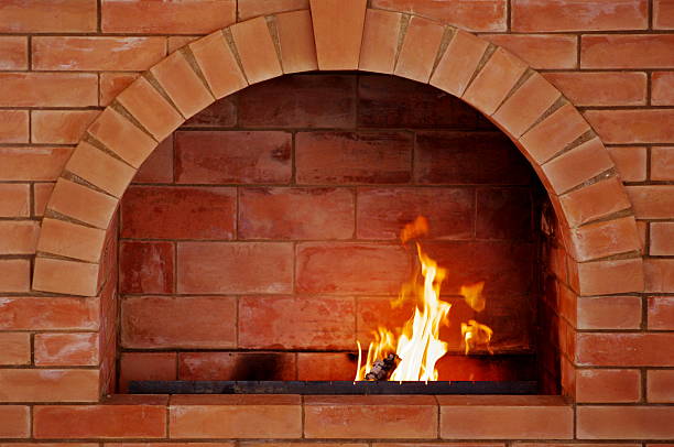 istock Brick oven in center of brick wall with fire lit 120240357