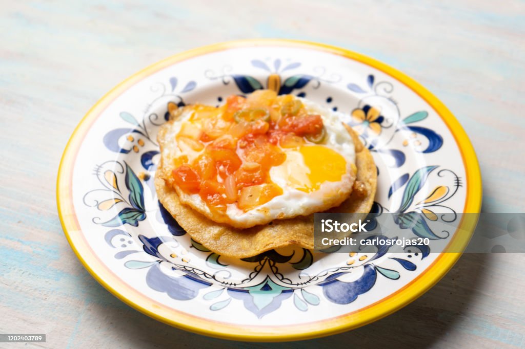 Mexican Egg Mounted On Corn Tortilla With Sauce Also Called Rancheros
