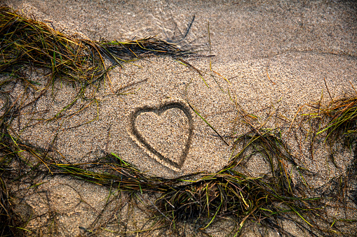 Hand drawn heart shape symbol on the beach