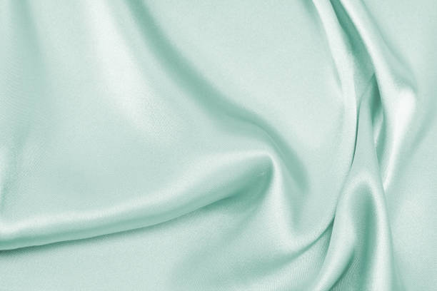istock Draped satin blue fabric for festive backgrounds 1202417086