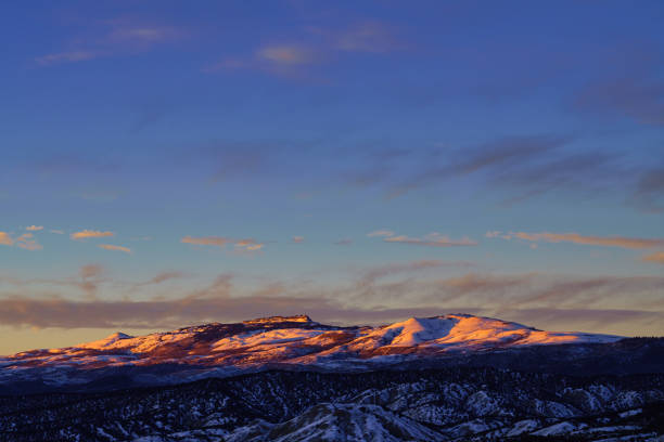 Castle Peak Alpenglow Mountain Landscape - Eagle Colorado mountain view of scenic iconic mountain with pink light in winter at sunset.