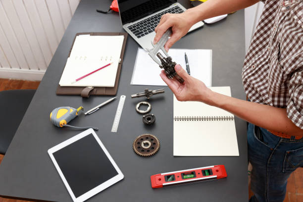 istock Engineer discussing and designing about mechanical gear parts in office. 1202418461