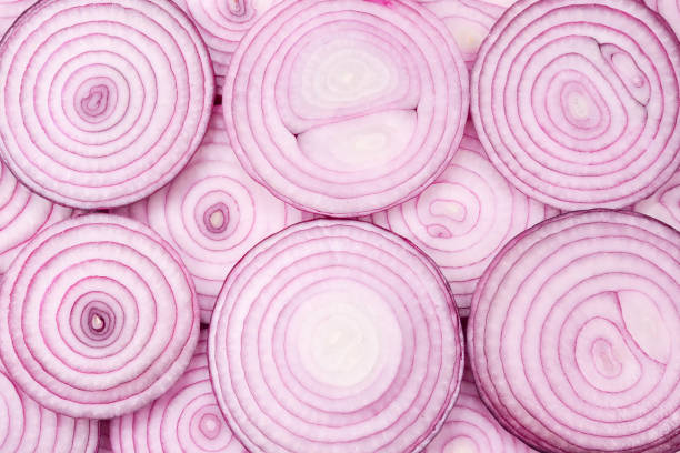 istock Onion slices as a background. Top view. 1202419986