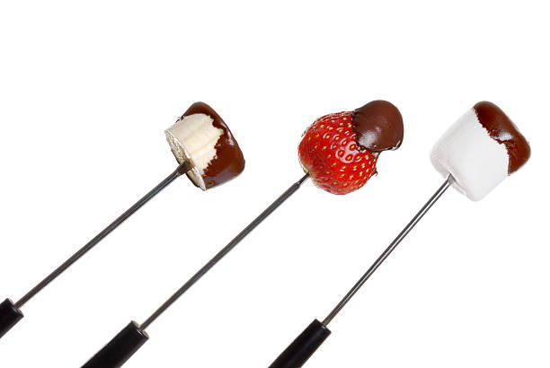 chocolate covered food on fondue stick isolated chocolate covered food on fondue stick on white background Chocolate Dipped stock pictures, royalty-free photos & images