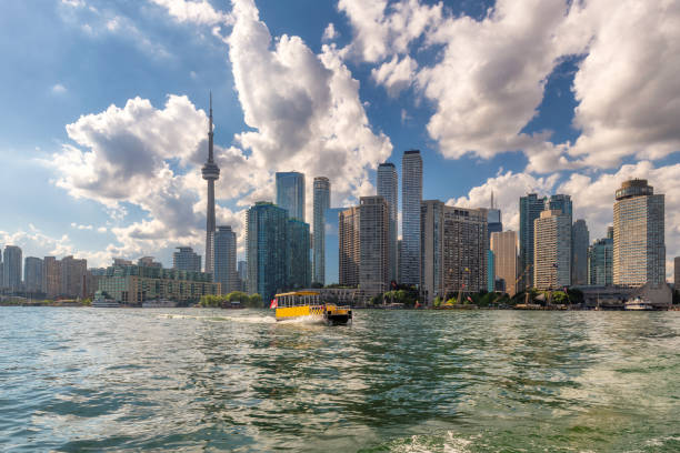 Toronto city skyline, Canada. Toronto city skyline with CN tower and water taxi in Ontario Lake at sunny summer day, Toronto, Ontario, Canada. watertaxi stock pictures, royalty-free photos & images