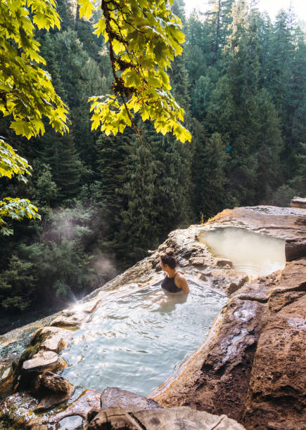 istock woman resting in an hot spring in oregon 1202436598