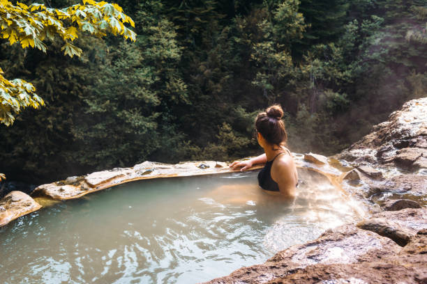 istock woman resting in an hot spring in oregon 1202436667