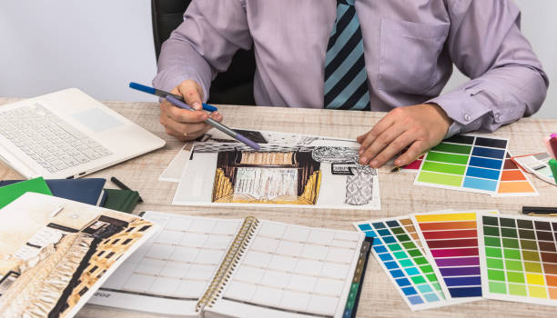 istock Engineer and architect concept - Designer creative working with  sketch plan blueprint and color sampler. 1202438338