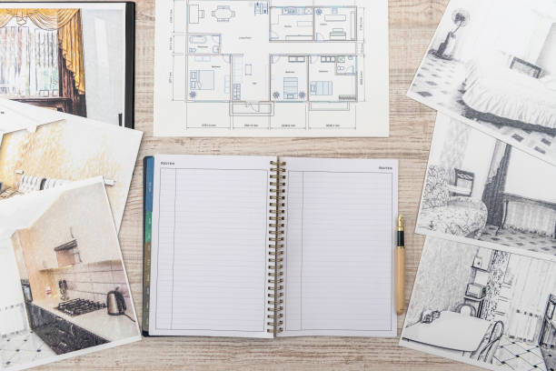 istock Unfinished  draft of classic room sketch, empty notepad, color tools on desk. 1202440155