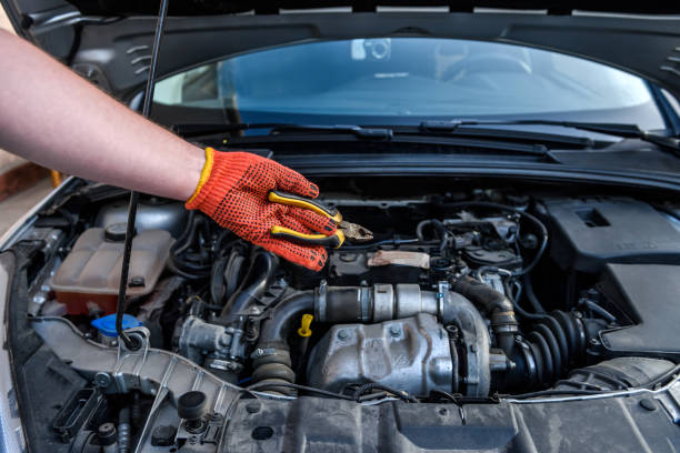 istock Hands with spanners and car engine close up. Car service concept 1202440448