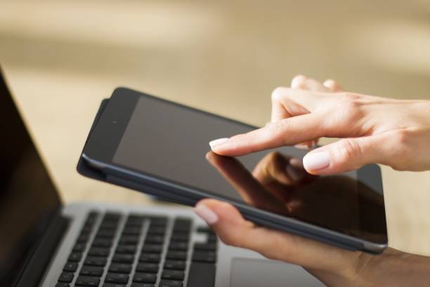 istock Woman hand clicks on digital tablet, closeup 1202440840