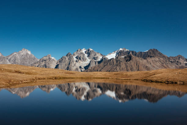 istock Caucasus mountains in autumn with lake in foreground 1202442796