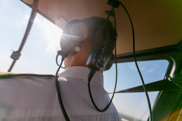 istock Flying a helicopter with headphones on 1202443988