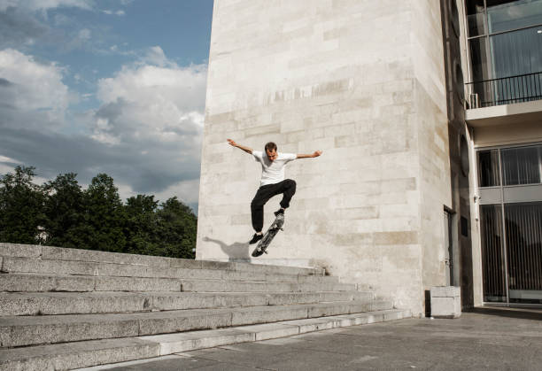 istock Skateboarder jumping from the steps. Skateboarding trick ollie. 1202445585