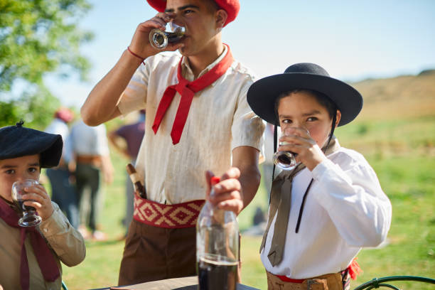 istock A gaucho boy drinking a cola during a barbecue. 1202445689