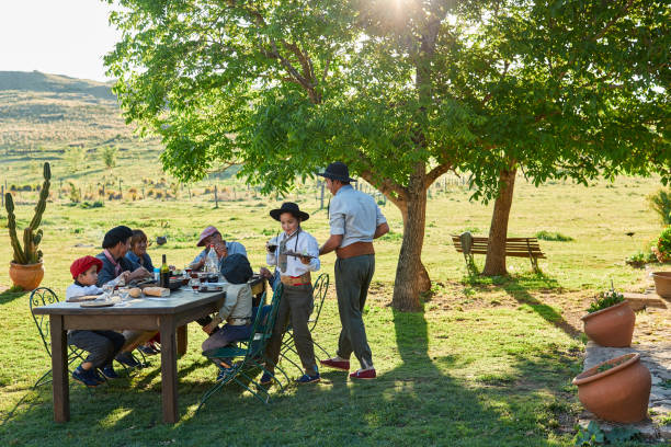 istock Family eating together under a tree. 1202445702