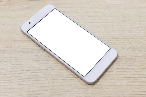 istock smartphone at wooden desk background. template for design. empty and minimalistic. 1202445804