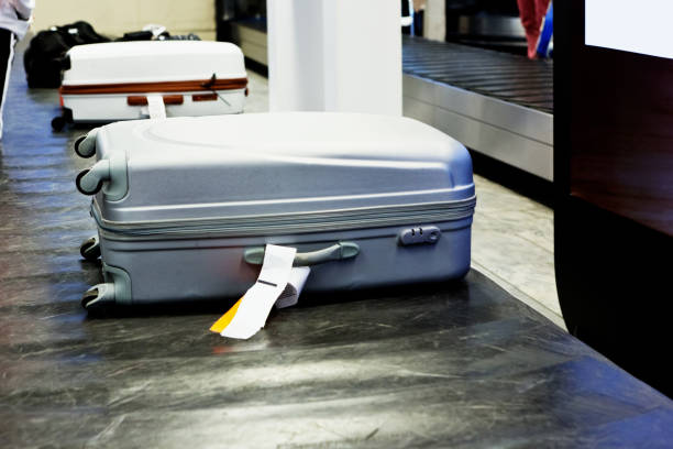 istock Baggage on conveyor belt at airport arrivals 1202446524