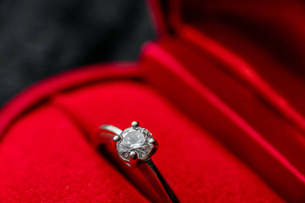 istock Beautiful macro shot diamond ring in red box 1202446961