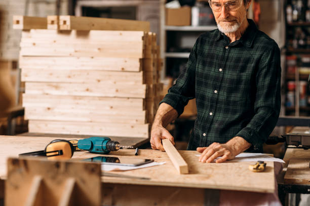 istock Cropped shot of mature carpenter standing at workbench in workshop 1202449256