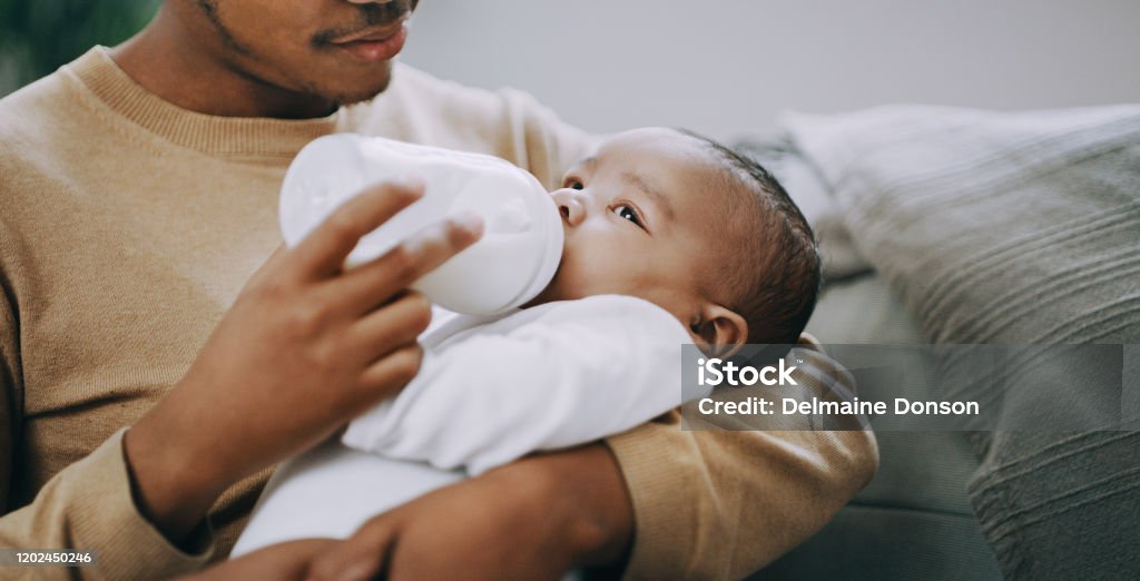 My boy deserves the best start in life Shot of an adorable baby boy being bottle fed milk at home by his father Baby - Human Age Stock Photo