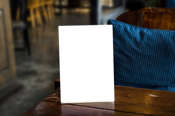 mockup blank menu frame on wood table mockup blank menu frame on wood table in restaurant blurred background restaurant table card stock pictures, royalty-free photos & images