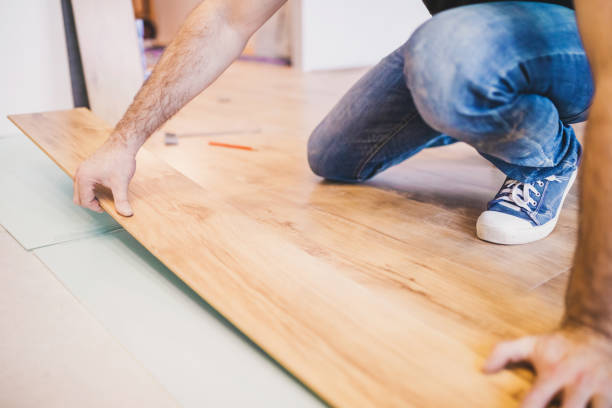 istock The builder is engaged in laying laminate in the room 1202455234