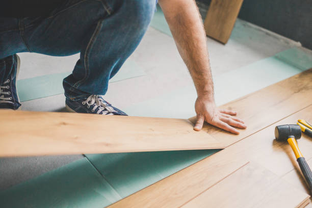 istock The builder is engaged in laying laminate in the room 1202455245