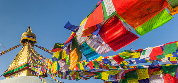 Panorama of prayer flags going up to the Boudhanath stupa in Kathmandu, Nepal