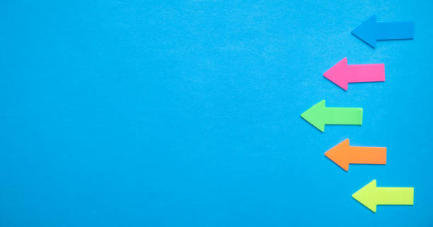 istock Colorful arrows on blue background. 1202456645