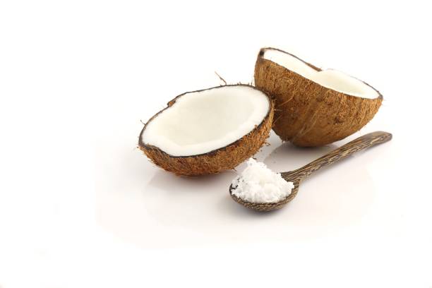 istock Fresh break coconut and spoon on white background 1202457646