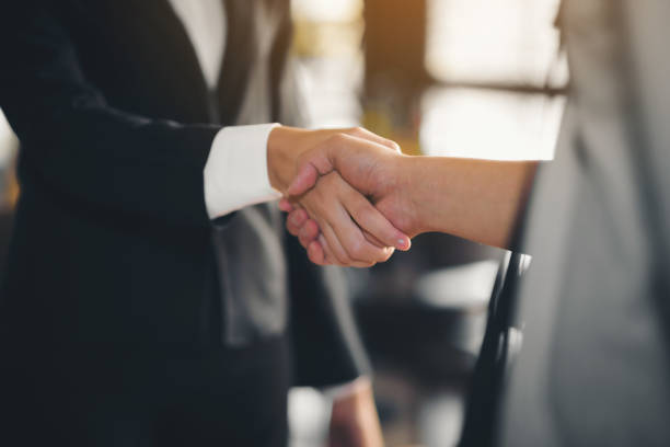 The hand of a businesswoman is shaking hands, check hands reached a business agreement. stock photo