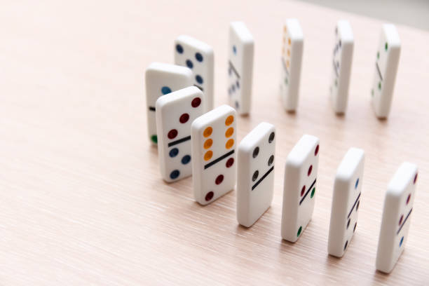 istock white dominoes stand in a row on a light surface, close-up 1202459236